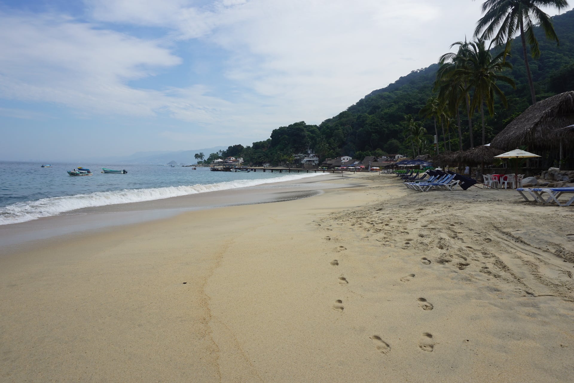 Footprints in the sand on an empty beach